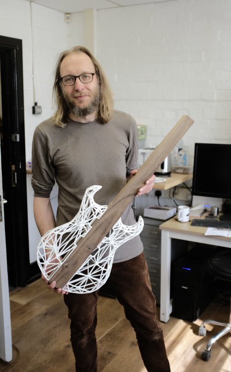 Michael stood in the workshop holding a work in progress version of his älgen guitar, which has a wooden core with 3D-printed mesh wings.