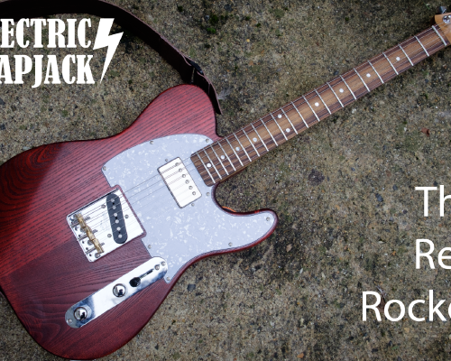 An electric guitar sits on a concrete background. It has a crimson red body, a pearloid white pickguard, and a maple neck with a rosewood fretboard.