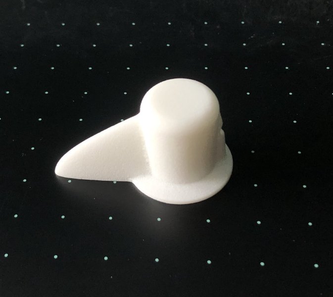 A selector switch control made in a white plastic.