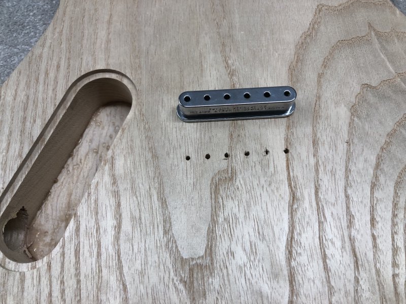 The rear of the guitar body showing a neat line of 6 holes, and the ferrule block that I now need to make a cavity for.