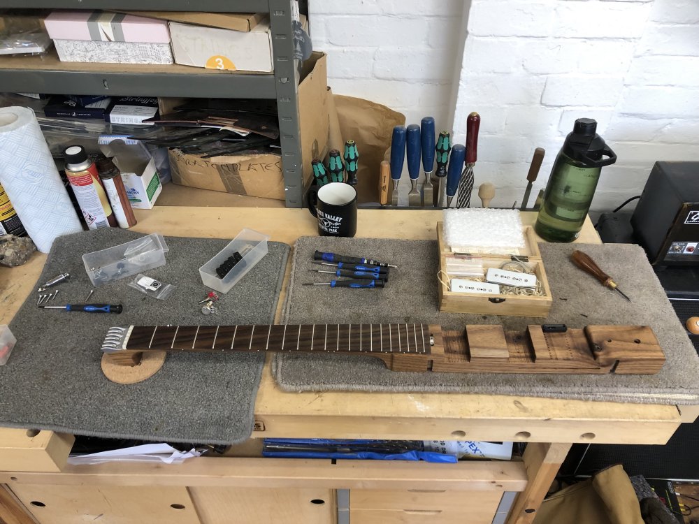 The neck and centre body part of the Älgen, which is one single piece of wood, sat on my workbench surrounded by parts and tools, ready to be put together.