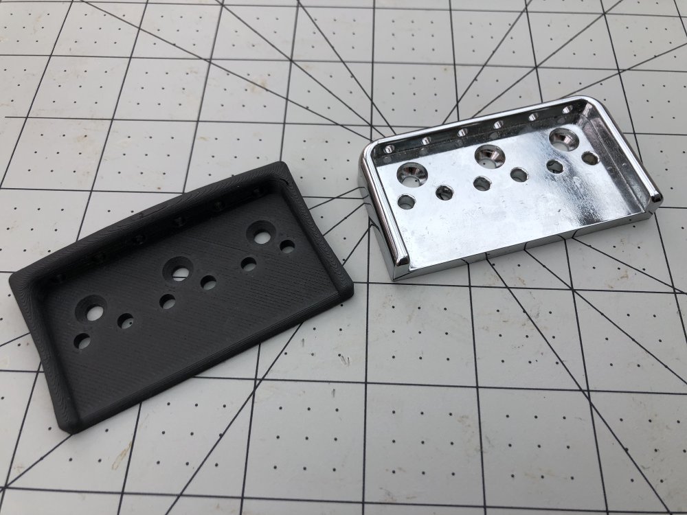 A side by side shot of the old chrome-plated metal bridge plate and my similarly sized but differently shaped 3D printed version.