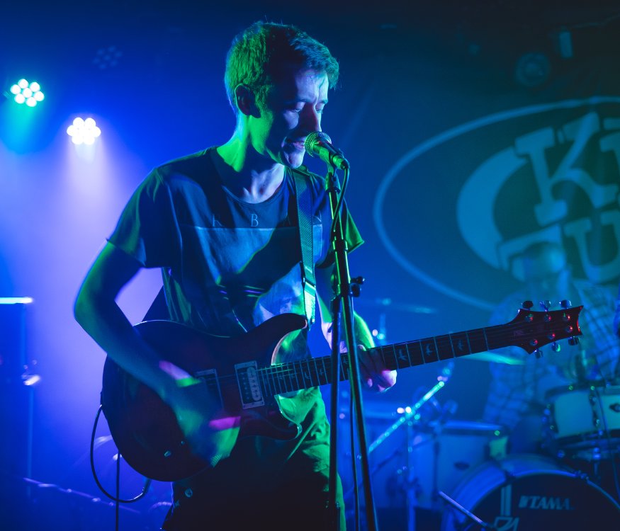 My brother on stage at King Tut's Wah Wah hut singing into a mic whilst holding a PRS guitar