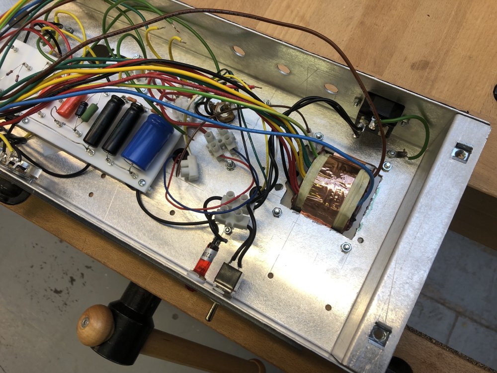 The amp chassis from the inside, and you can see the crude hole I made where the new transformer sits.