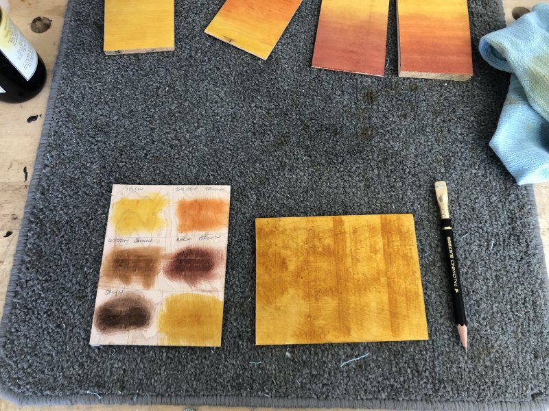 Another postcard sized bit of maple, this time divided up into six areas, five of which have a splodge of colour in them labelled in pencil: yellow, golden yellow, golden brown, red brown, and brown. In the last square and entirely covering another postcard sized bit of maple is a richer yellow than we've seen before.