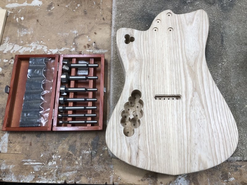 The now familiar back of this guitar body, and in addition to the neat pocket made for the ferrule block,  you can see two collections of overlapping large-bore holes drilled into it.