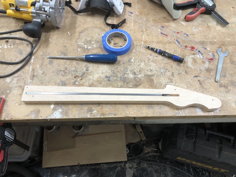 The work-in-progress neck is sat on the workbench with the truss-rod in the channel I cut down the middle.