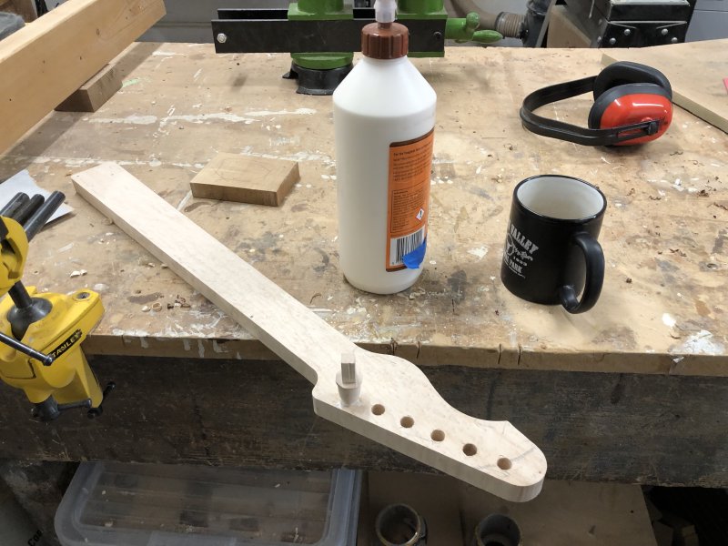 You can now see the peg is plugged into the hole that was too large in the headstock of the neck. Beside it sits a large tube of wood glue and an empty cup of (what was) tea.