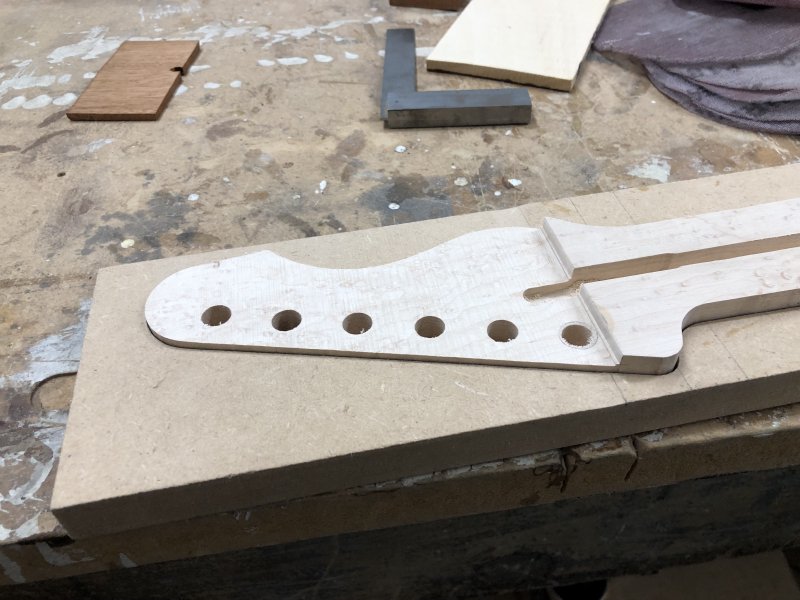 A close up of the neck, where you can see the face of the headstock is now lower than the remainder of the neck. You can also see that where I've had to patch the hole for the tuner all the mess has gone.