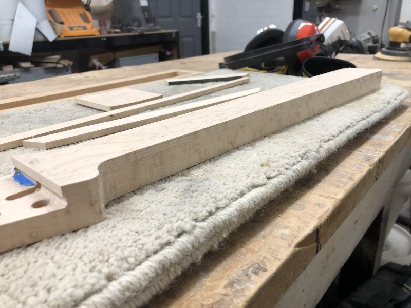 The neck sits back on the workbench, with fretboard trimmed to match the profile of the lower part of the neck. It's still very blockly, as it's still early in the process, with no back carve or headstock transition, but you can tell now it's going to be a guitar neck.