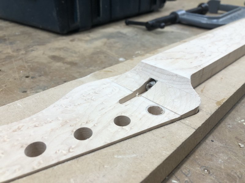 A close up on the headstock transition on the neck. Whilst there is still some work to be done, you can see the rounding is mostly finished, and importantly there are no burn marks or any signs of where the material de-laminated.