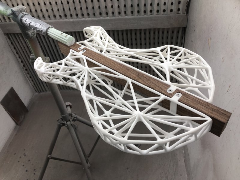 A view of the 3D-printed lattice-work guitar body in the spray booth ready to be sprayed.