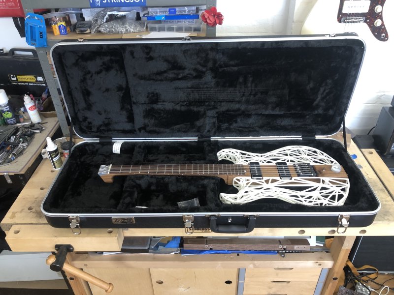 Älgen guitar sits in a hard-case on my workbench, ready to finally ship out.