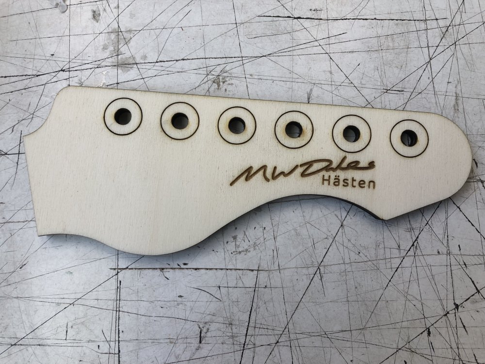 Another laser-cut plywood headstock mockup, with now the signature bit looking a little bit more distinctive.