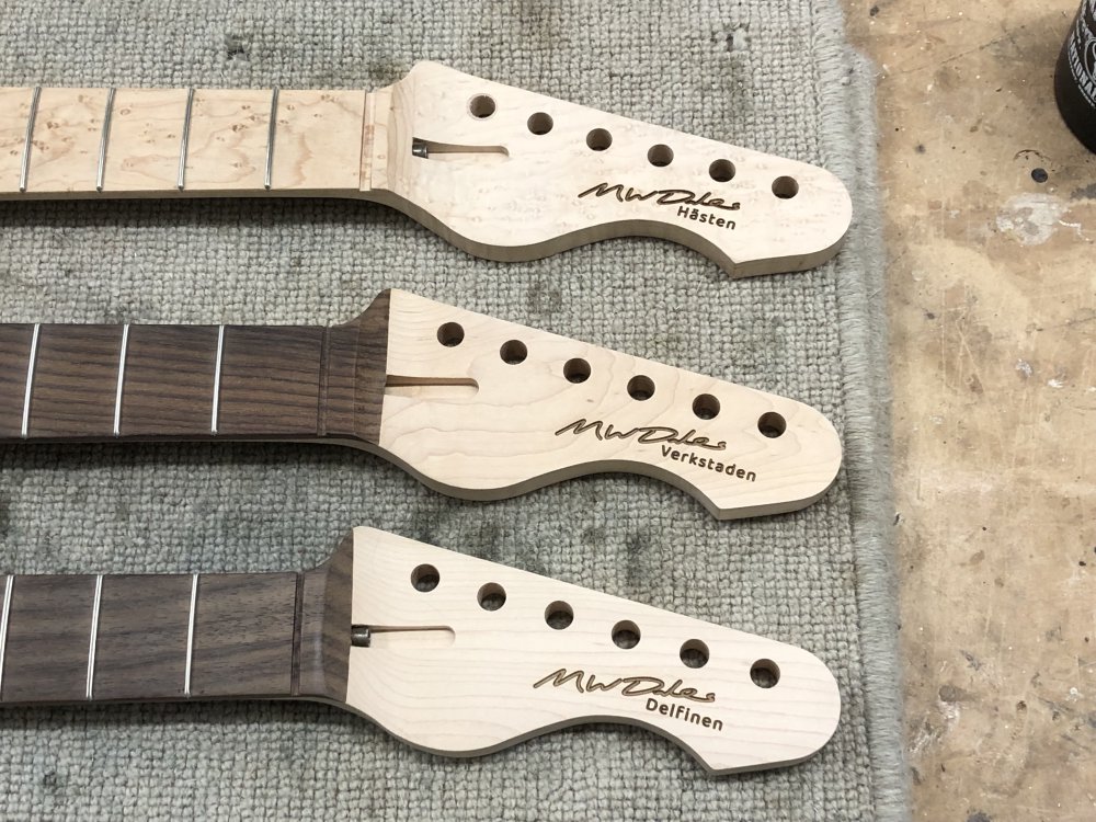 Another close-up of the three headstocks, and now the signature and guitar name on the headstock looks crisply defined.
