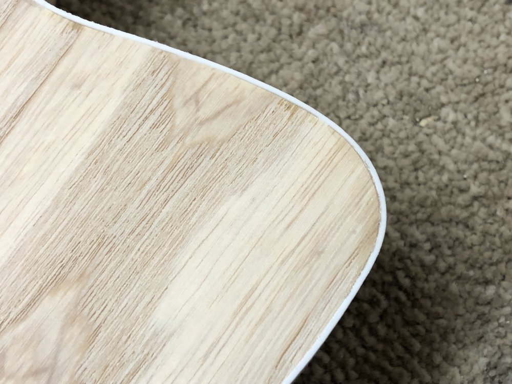 Another close up of the same section of the guitar, and now the binding has no gap with the guitar body, but there is a visible glue line.