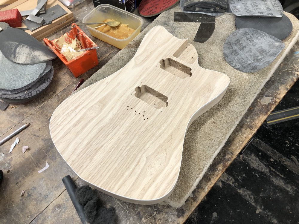A further-away photo of the guitar body so you can see the hole thing. Now you can't see the glue line.