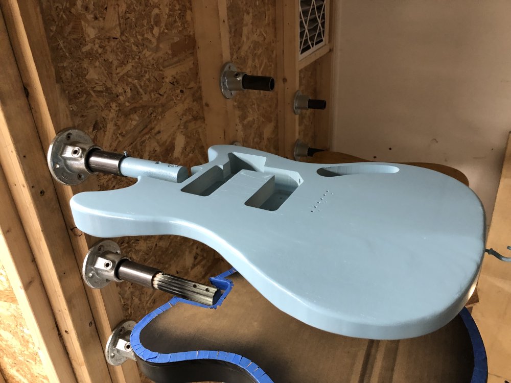 The same photo as before of the two guitars mounted on the wall, but the blue one is now just that bit more consistent in colour.