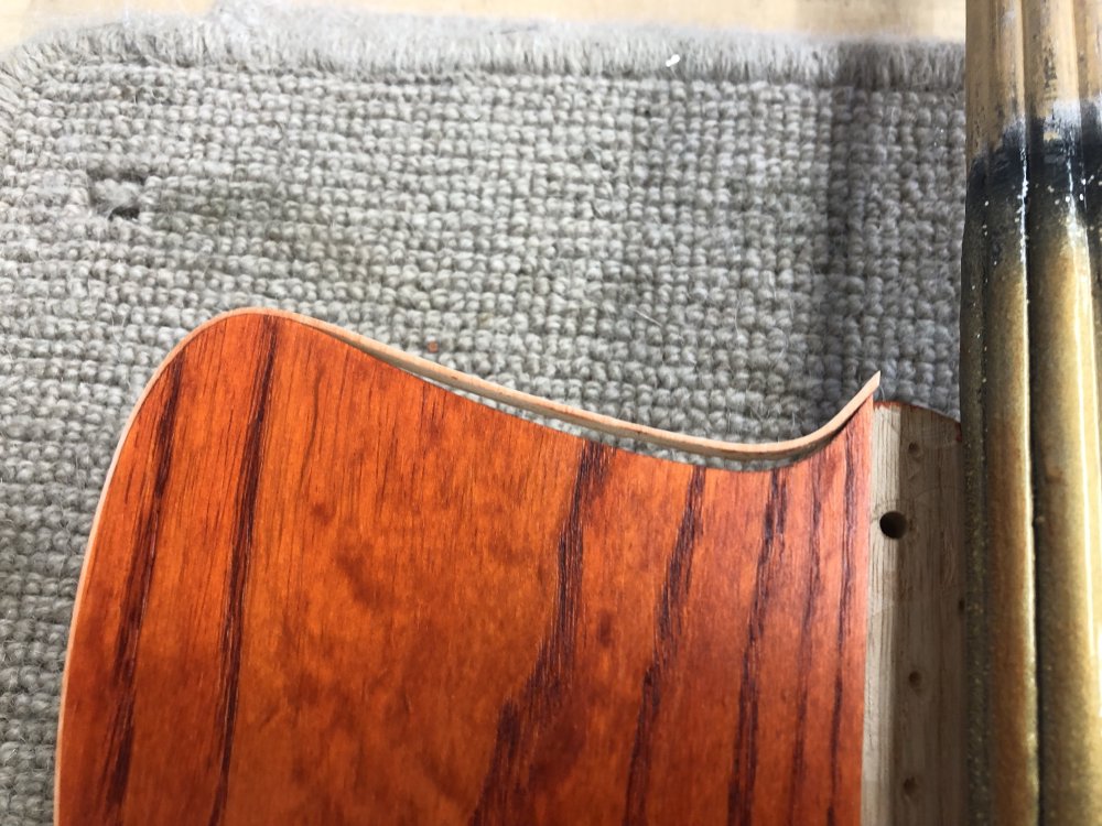 Another photo of the top left of the face of the guitar, and now you can see the binding all along that top edge has come away from the body.