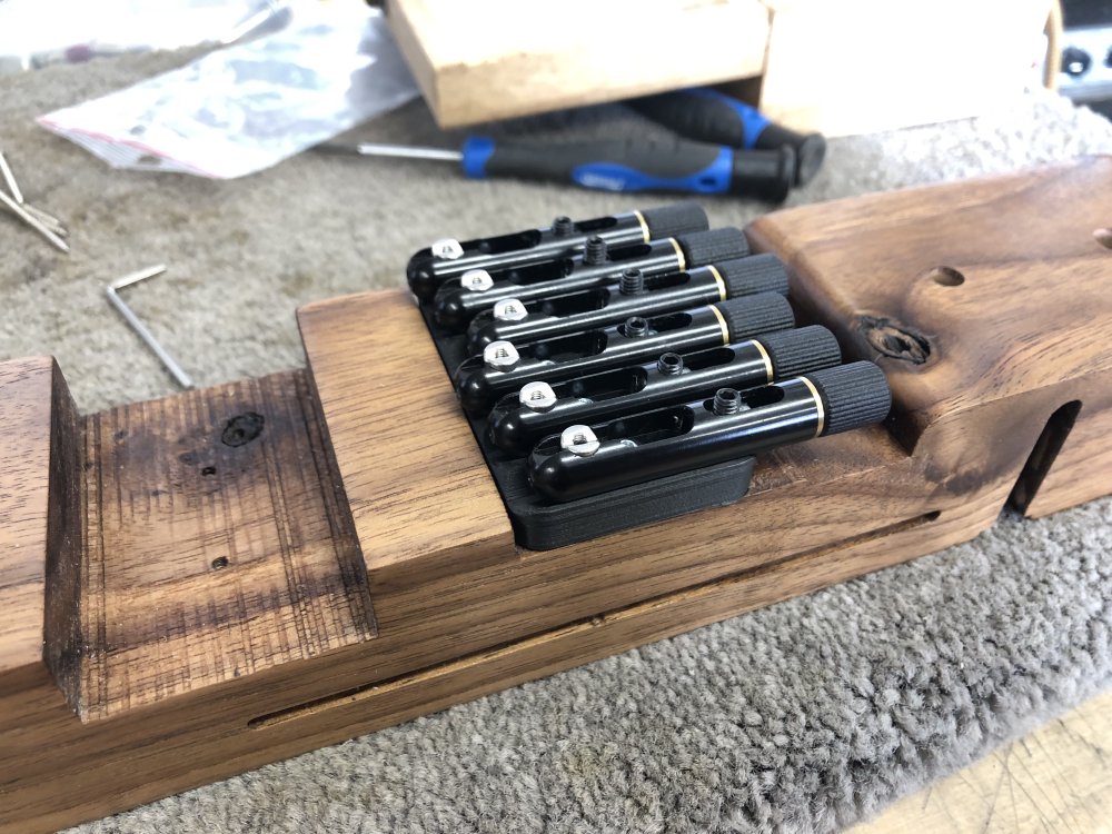 A photo of the assembled bridge unit with all its parts now mounted on the guitar using the new 3D-printed bridge plate.