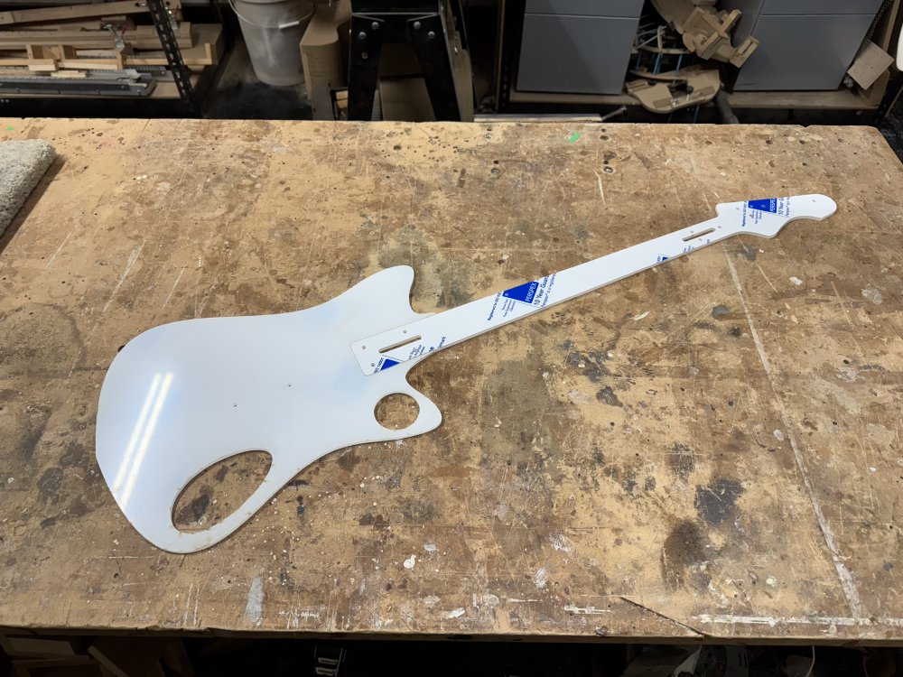 A photo of the body template and the neck template put together on a workshop workbench.